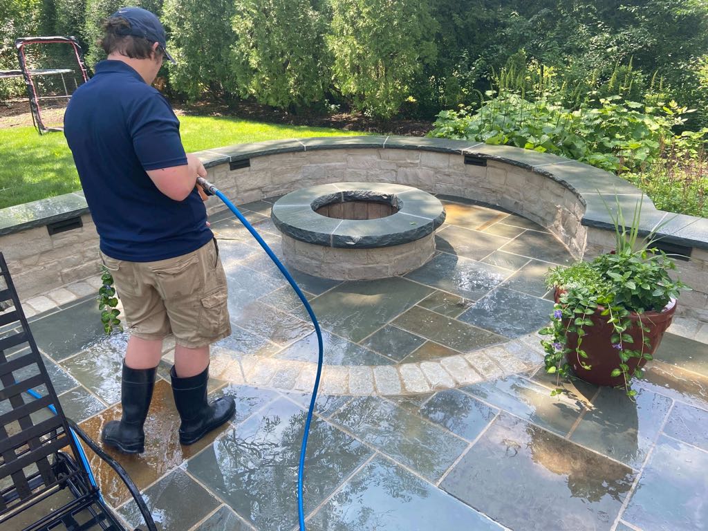 Close up of bluestone patio being pressure washed.