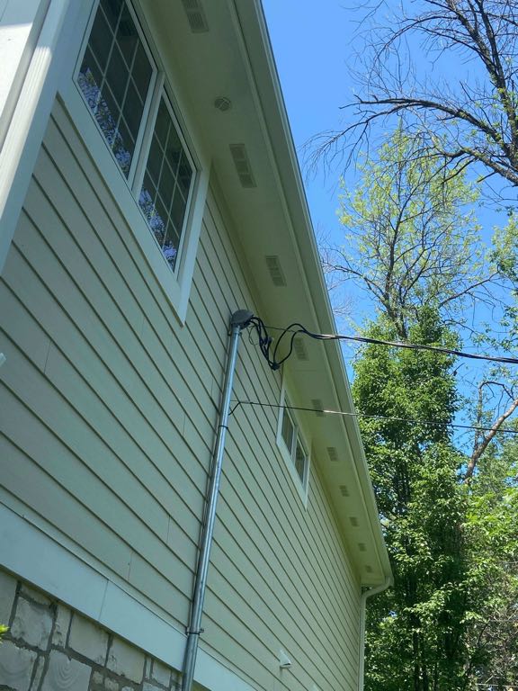 Side view of house displaying white clean soffits and gutters.