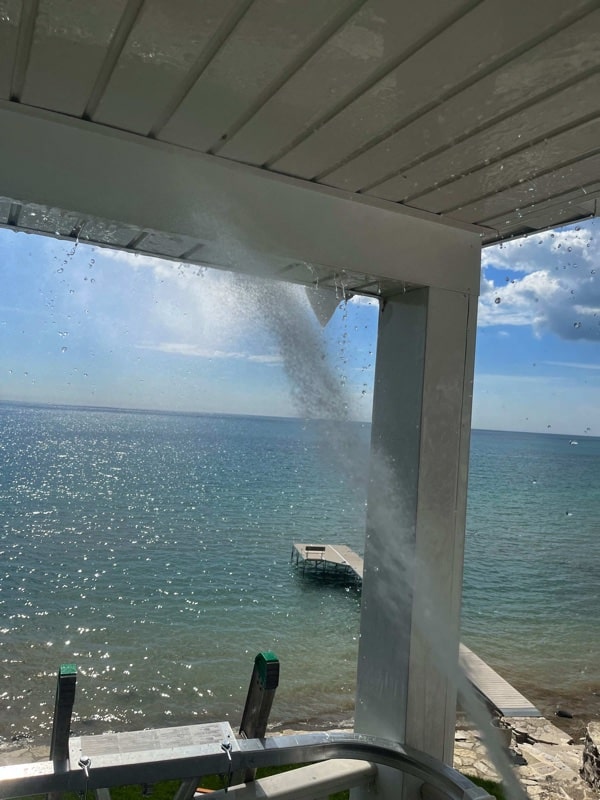 Inside balcony being pressure washed looking over Lake Michigan in Bayside.